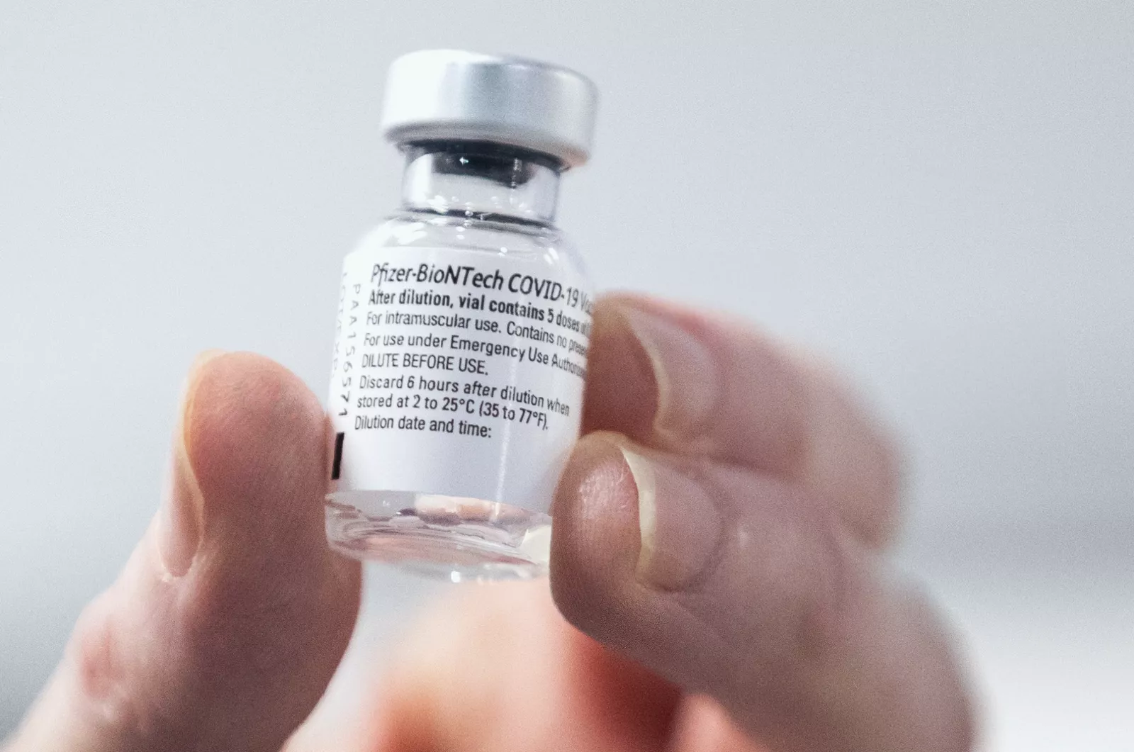 Expired Covid-19 vaccine vials being prepared for disposal.