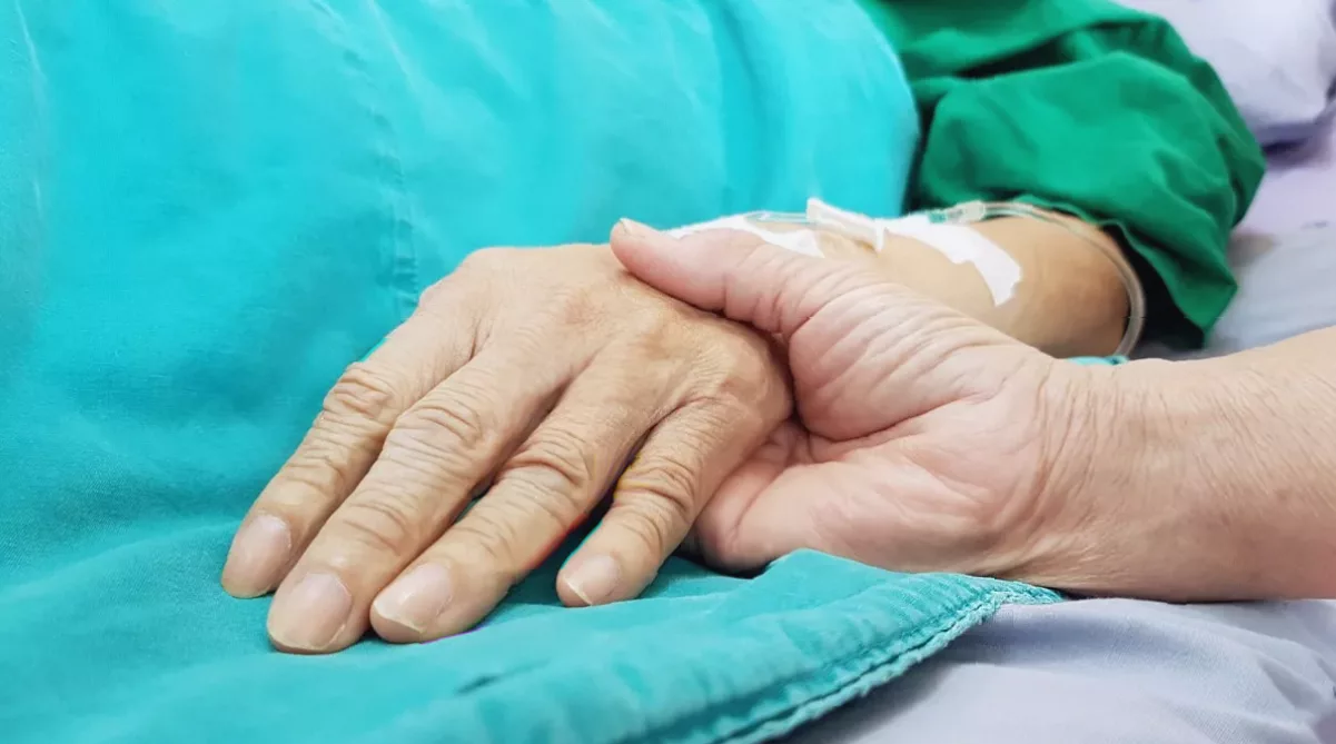 A healthcare professional consulting with a patient in a hospice setting.