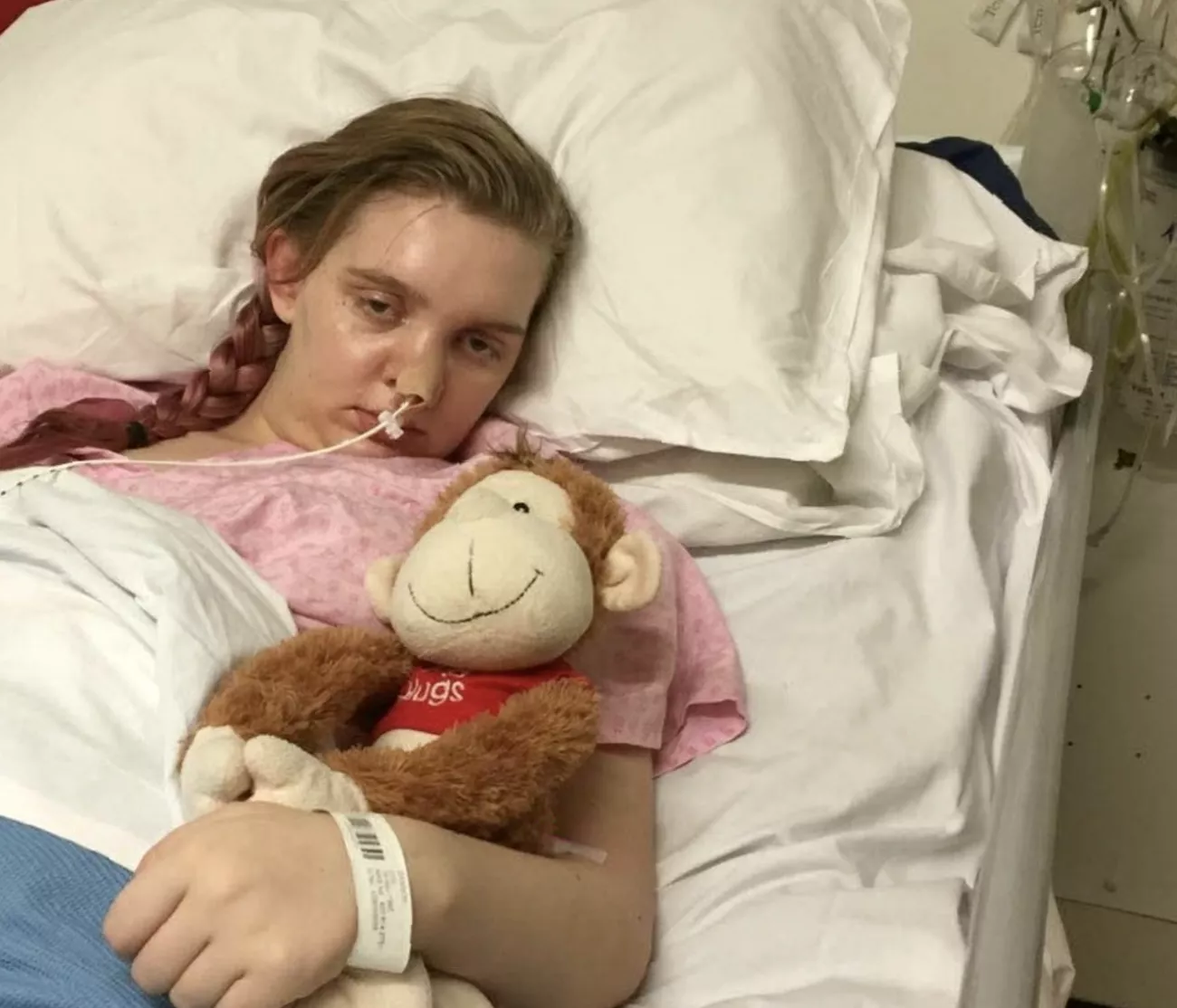 A person sitting on a hospital bed in a psychiatric ward.