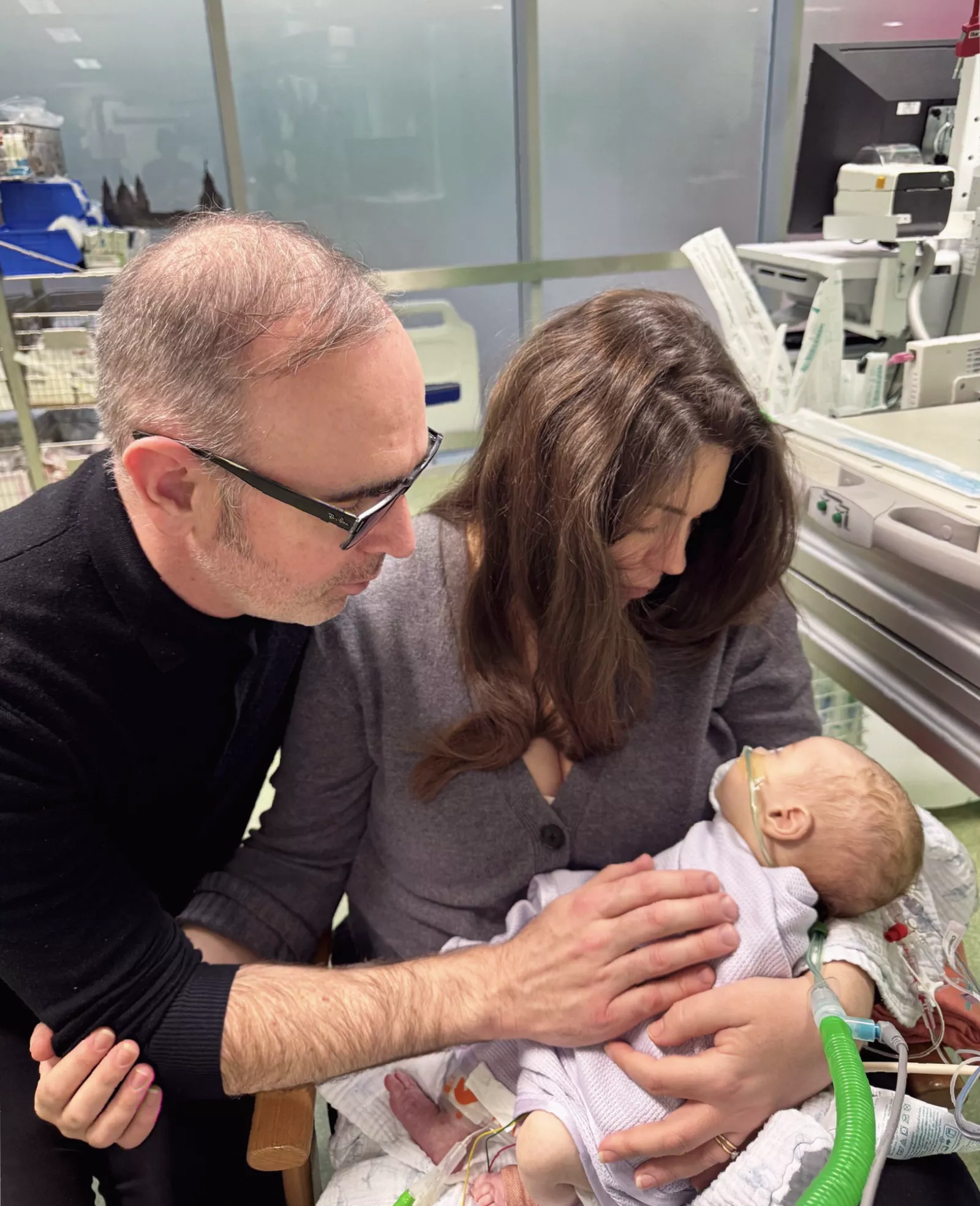Surgical team performing open-heart surgery on an infant in an operating theatre