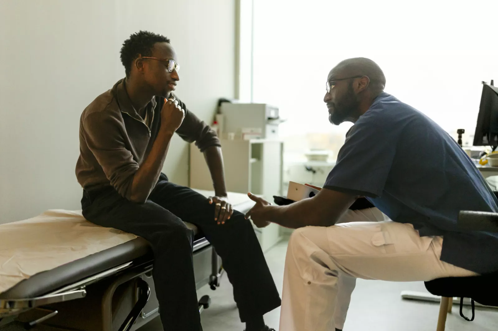 Doctor consulting with a male patient about urological health.