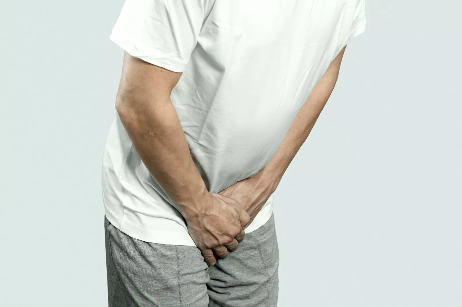A doctor consulting with a male patient about urological health symptoms.