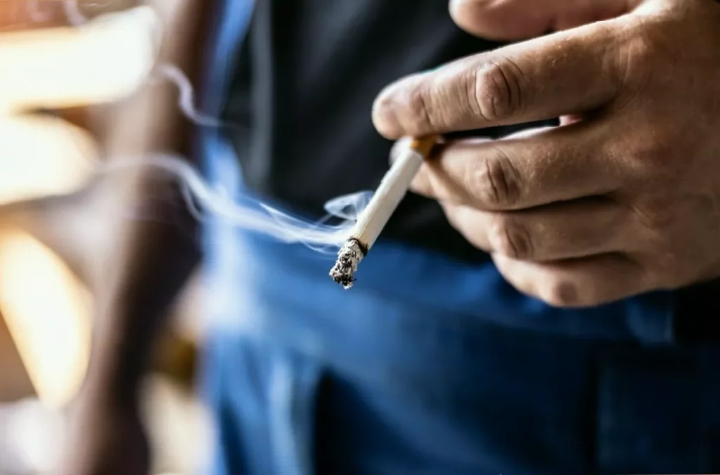 UK to implement permanent cigarette ban for those born in 2009 or later UK Parliament building with a no smoking sign displayed outside.