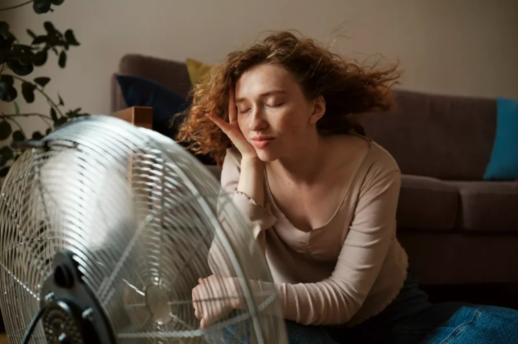 13 easy low-cost ways to cool your home without aircon A homemade air conditioner made from a frozen saltwater bottle placed in front of a fan