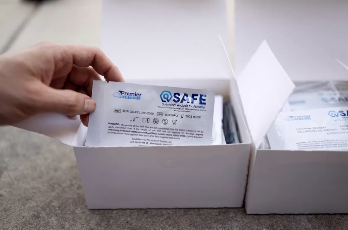 Naloxone nasal spray being administered in a community outreach setting