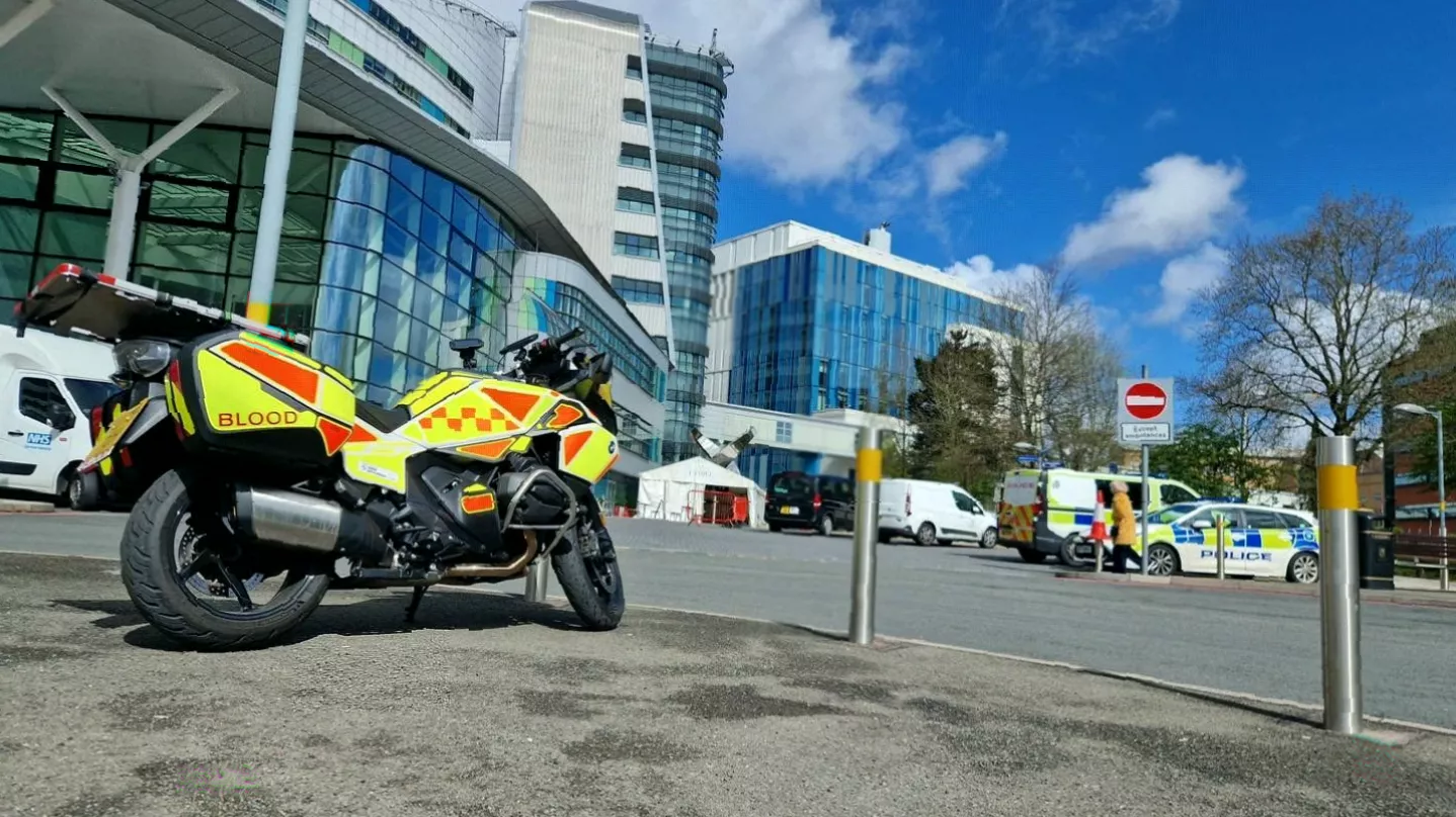 BMW R1250RT blood bike parked outside a hospital delivery entrance