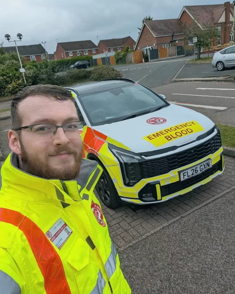 Volunteer motorcyclist transporting blood samples for NHS hospitals at night