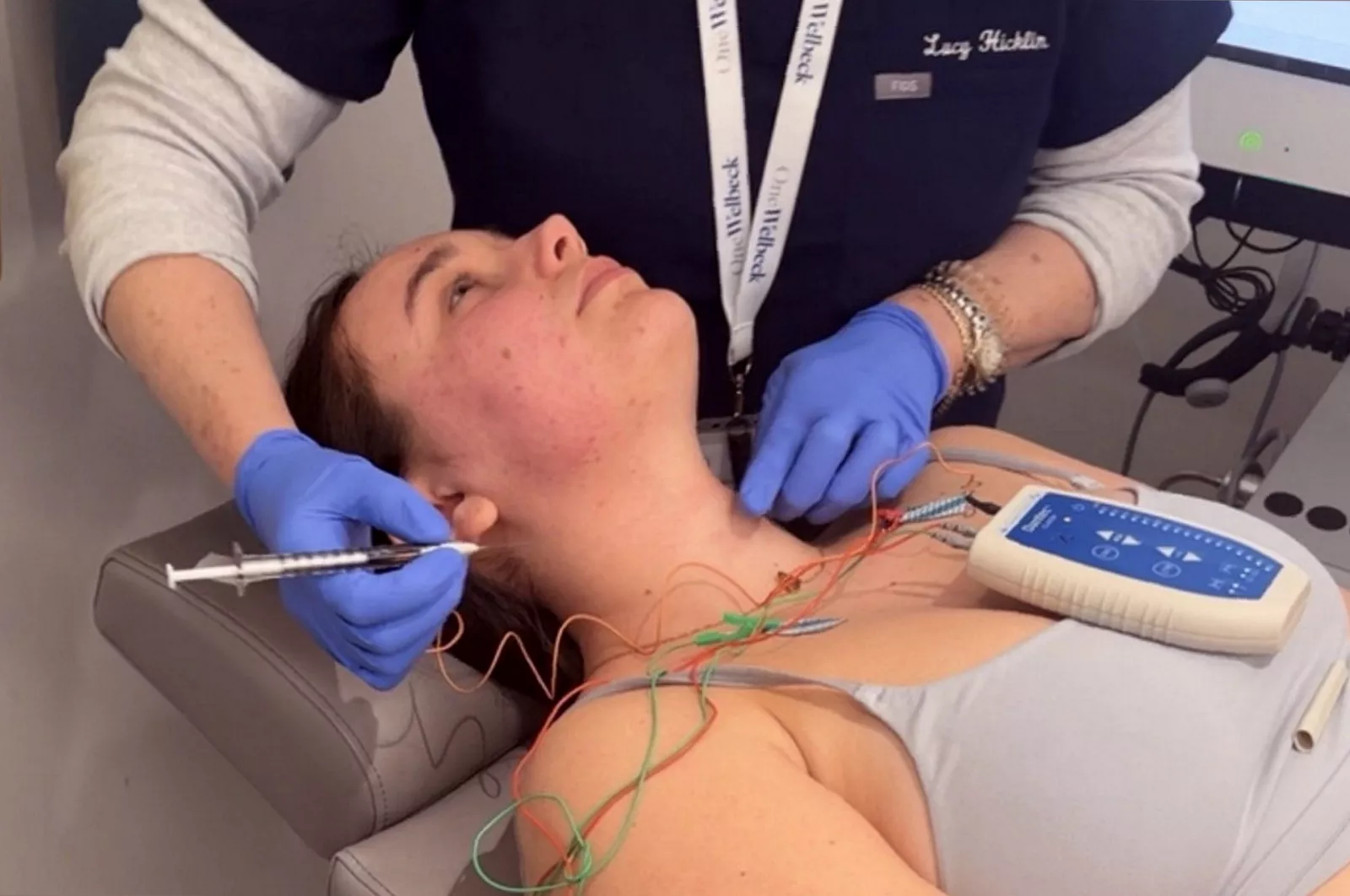 Doctor administering Botox injections into a patient's throat to treat a swallowing muscle condition