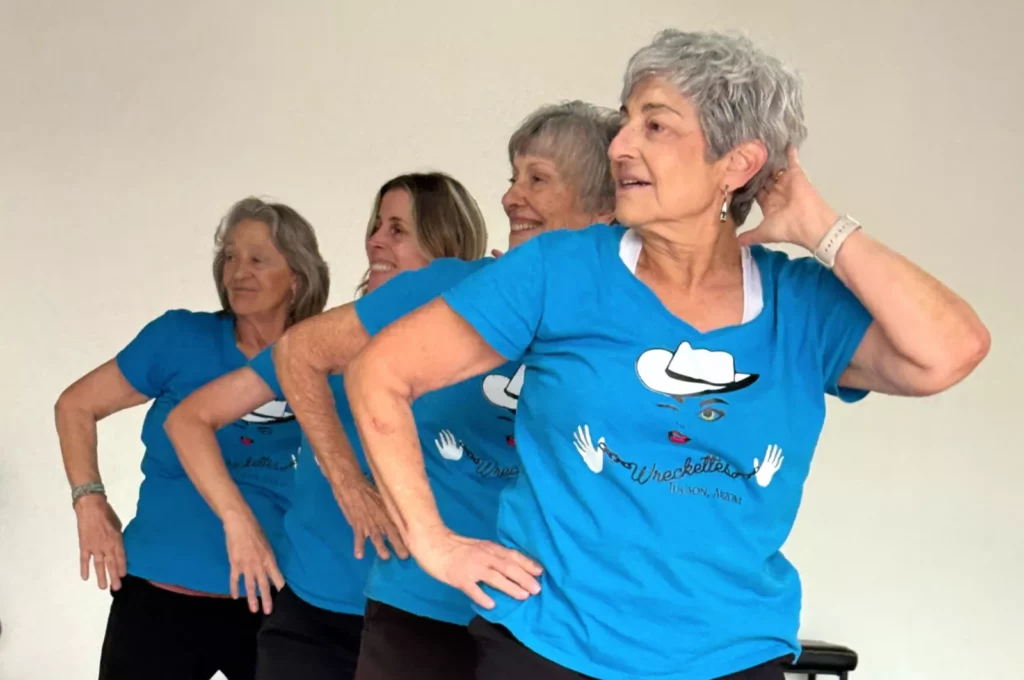 Dance among the best forms of exercise for ageing healthily Older women in matching sparkly costumes perform a dance routine on stage