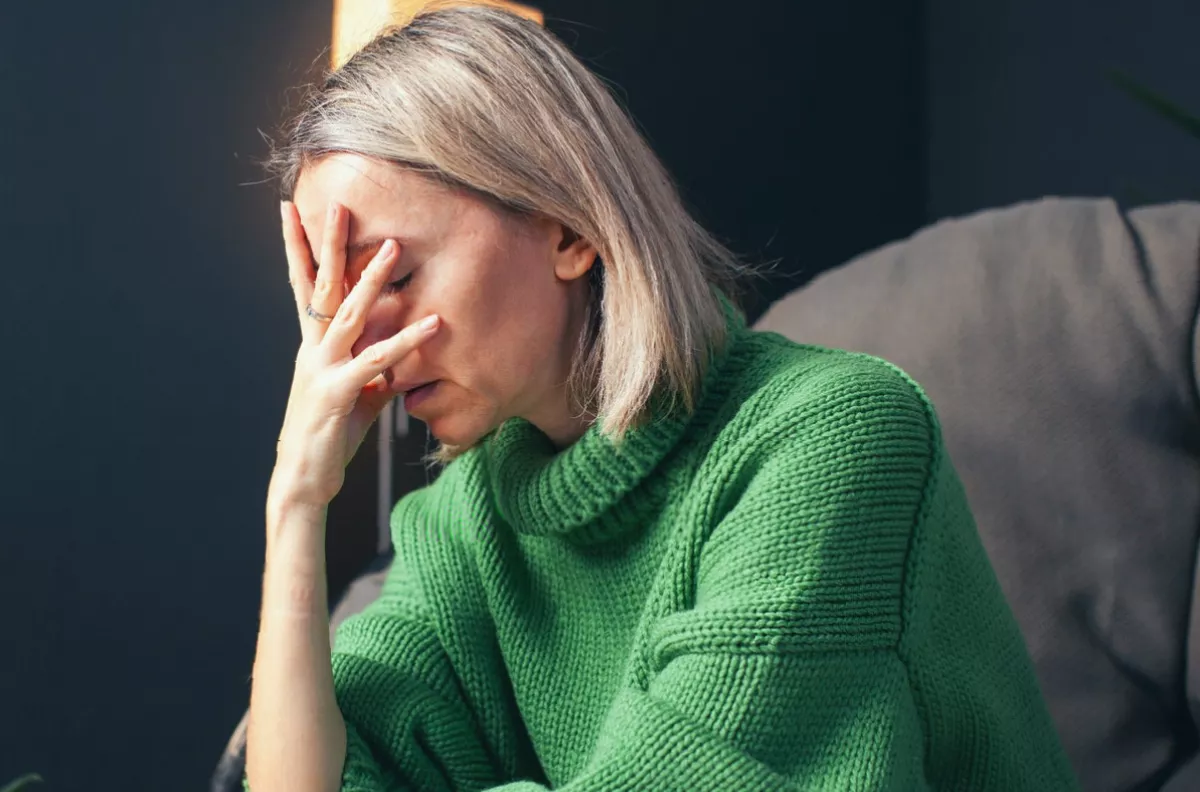 A person using an asthma inhaler while looking at a weight management prescription