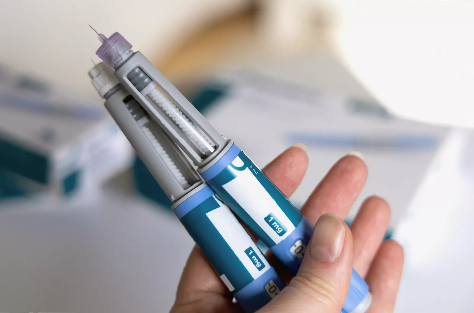 Close-up of Mounjaro and Wegovy injection pens on a consultation room desk