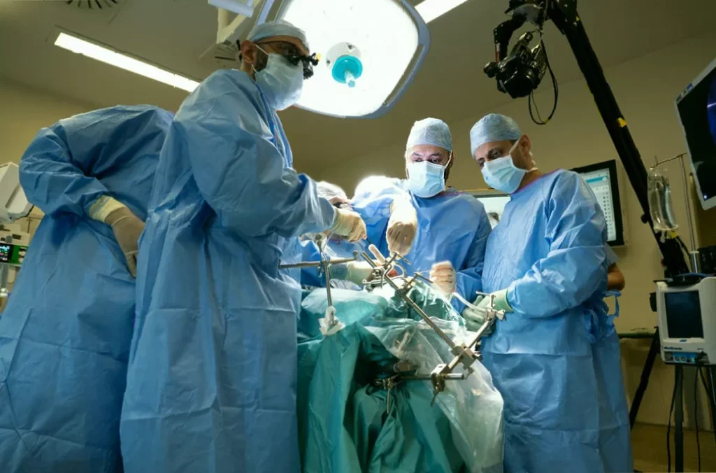 Surgeon reviewing a 3D-printed model of a patient's skull base and eye socket