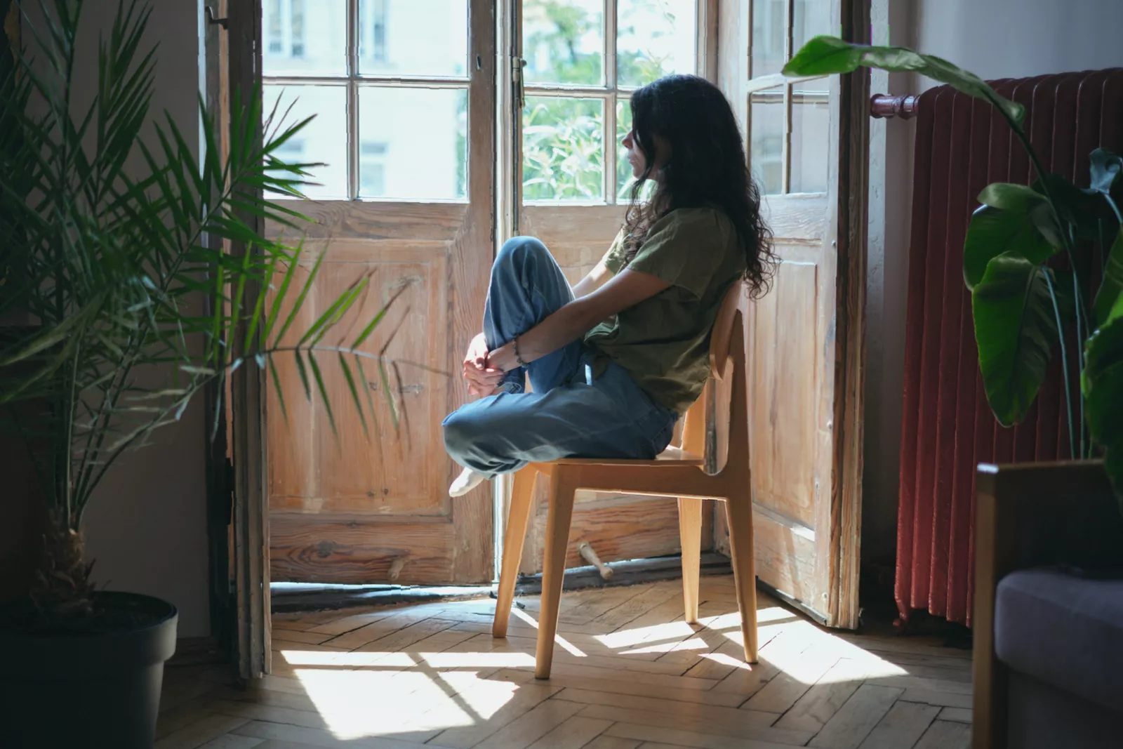 A person standing up from a desk chair to stretch during a work break