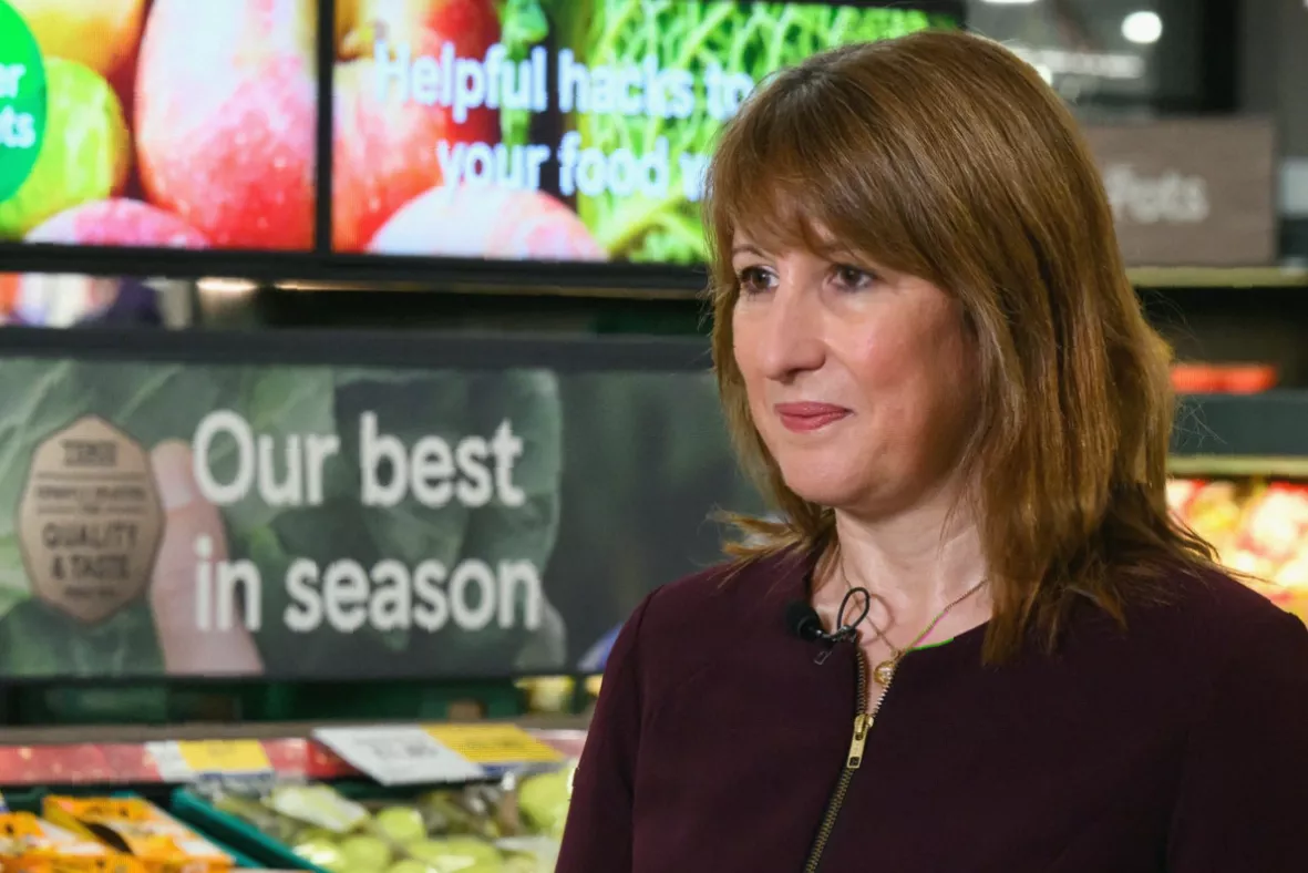 A nutritionist reviewing food labels on ultra-processed snack packages in a clinic