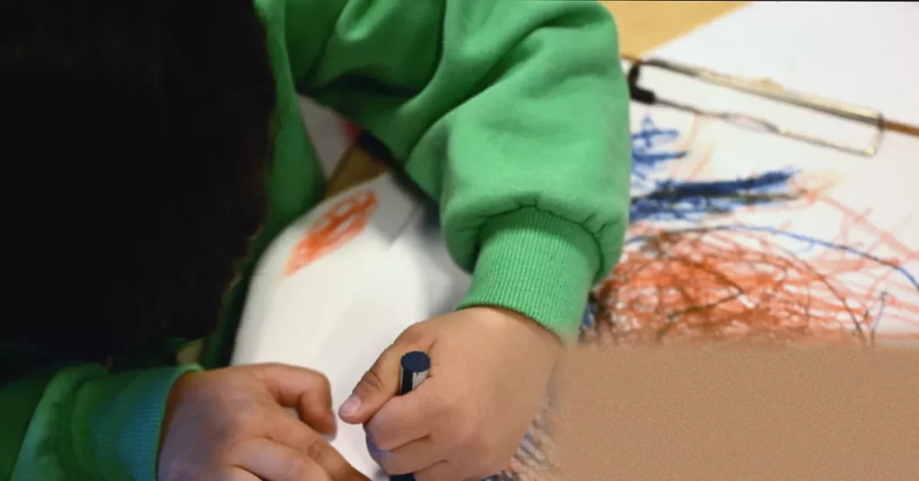 Children painting in a school art class, focused on creative projects