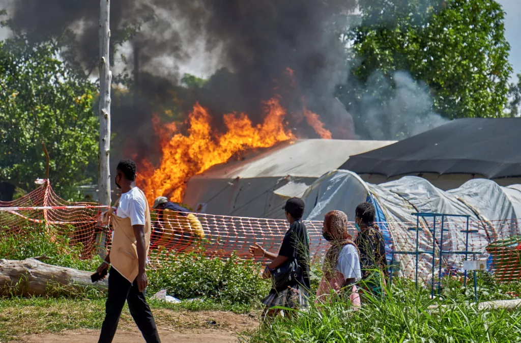 Flames engulfing white medical tents at a hospital in Ituri Province, DRC