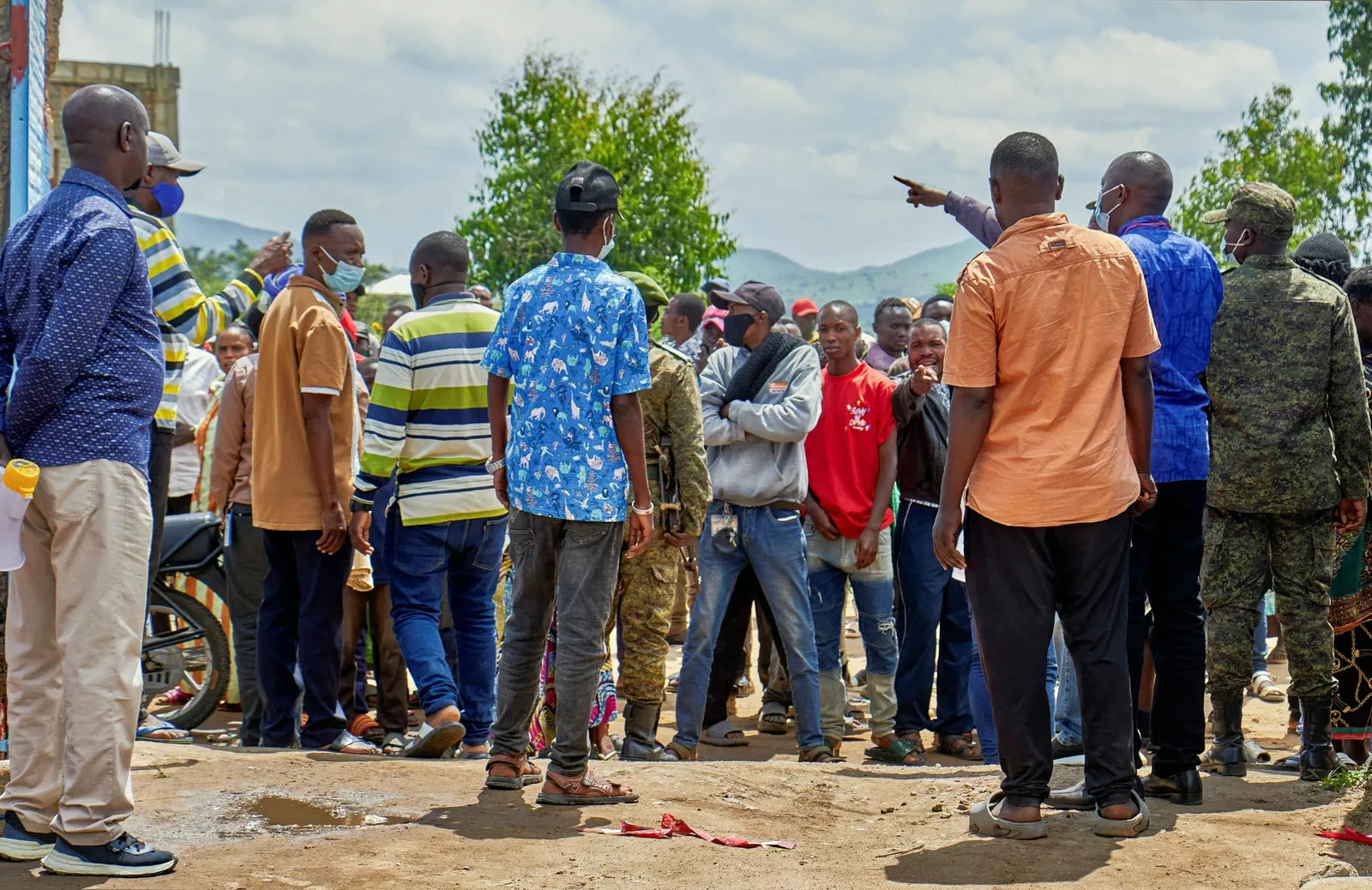 Congolese health workers in protective suits moving patients away from burning tents