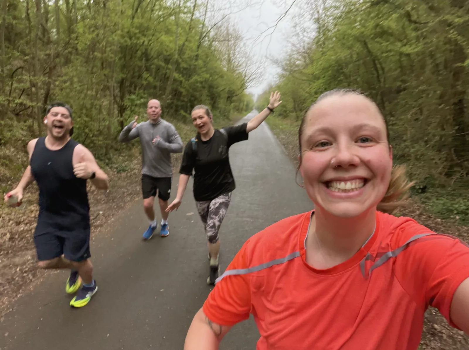 Teacher runs past Buckingham Palace with crowds waving and cheering
