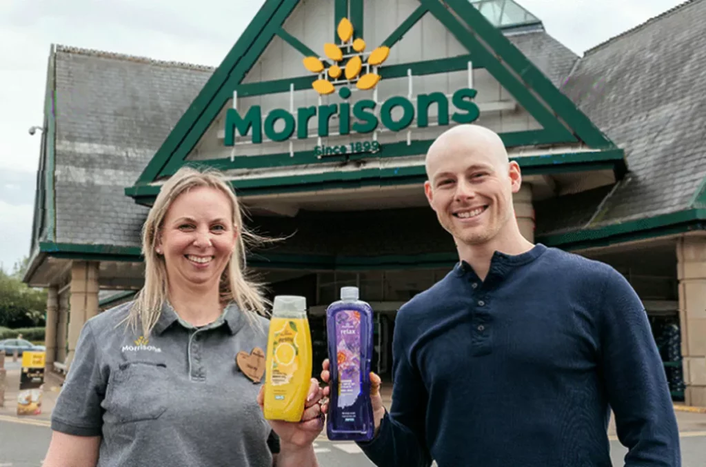 Morrisons own-brand shower gel bottles with NHS cancer symptom reminders on the labels