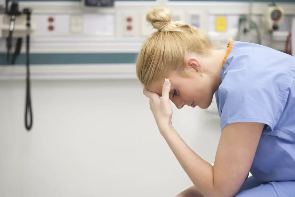 Patients at risk from slump in nurse staffing growth and more complex conditions, research says Hospital ward with nurses attending to patients under pressure