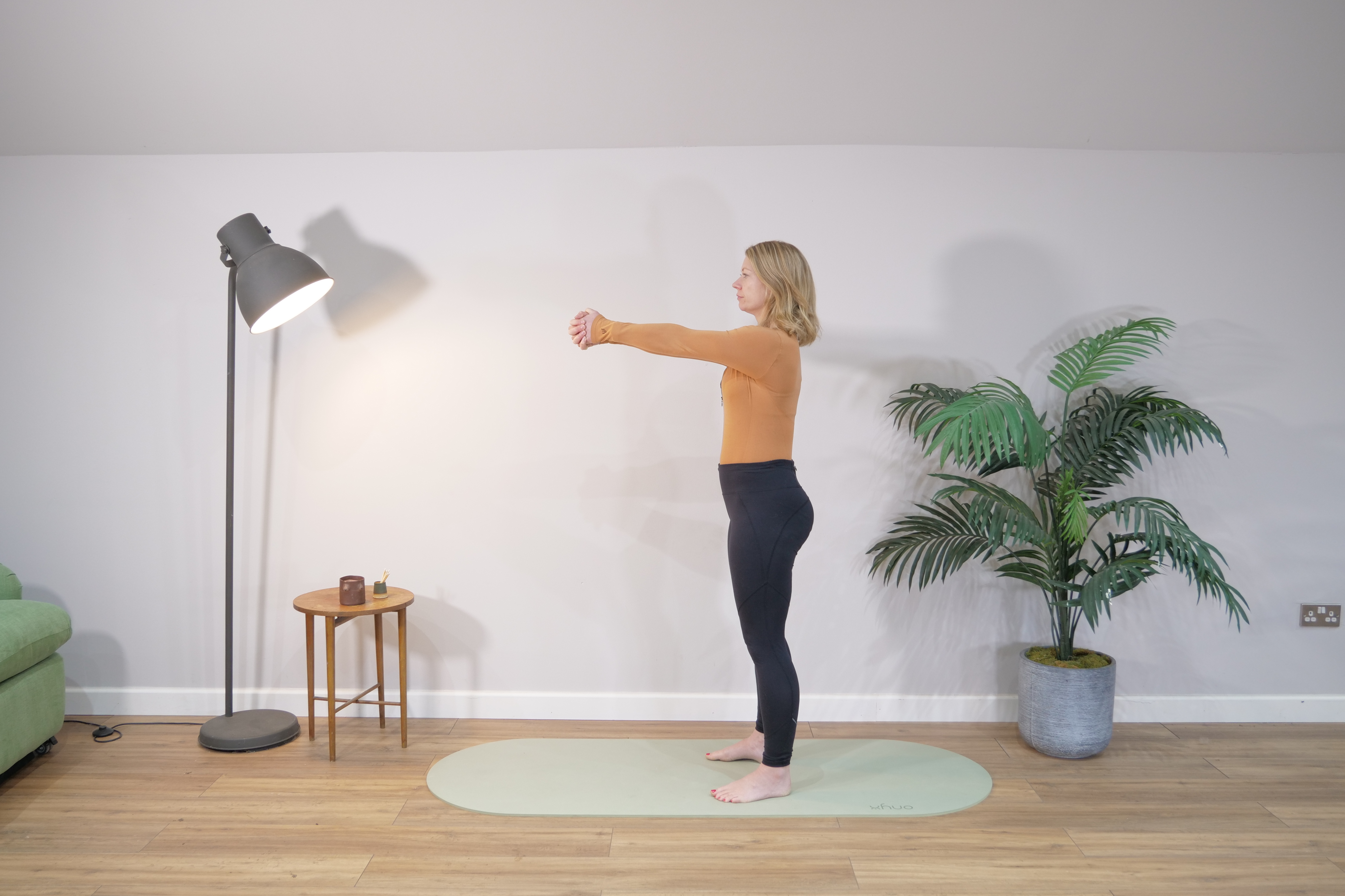 Hands clasped in front during a standing anti-rotation hold
