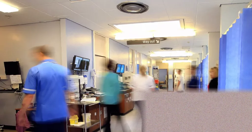 Streeting cites improvement in England’s hospital waiting times Hospital corridor with patients waiting in chairs for appointments