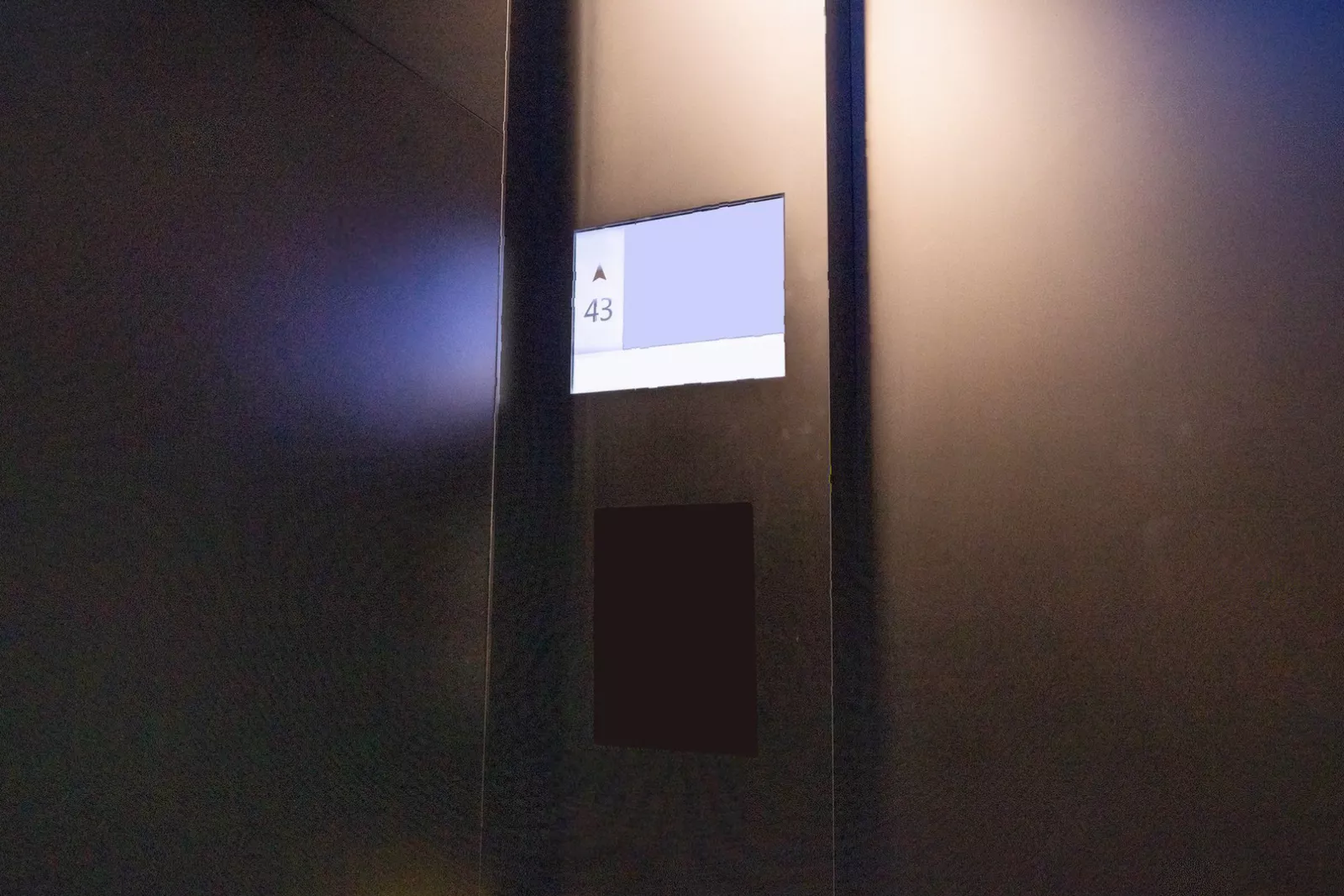 Engineers inspecting a dated lift mechanism in a UK commercial building