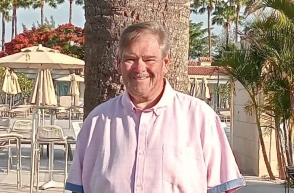 A heart failure patient using a wearable mini-pump device at home to self-administer medication