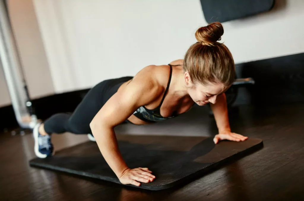 Age dictates how many press-ups you ought to achieve Man in his twenties performing a full-range press-up with proper spine alignment