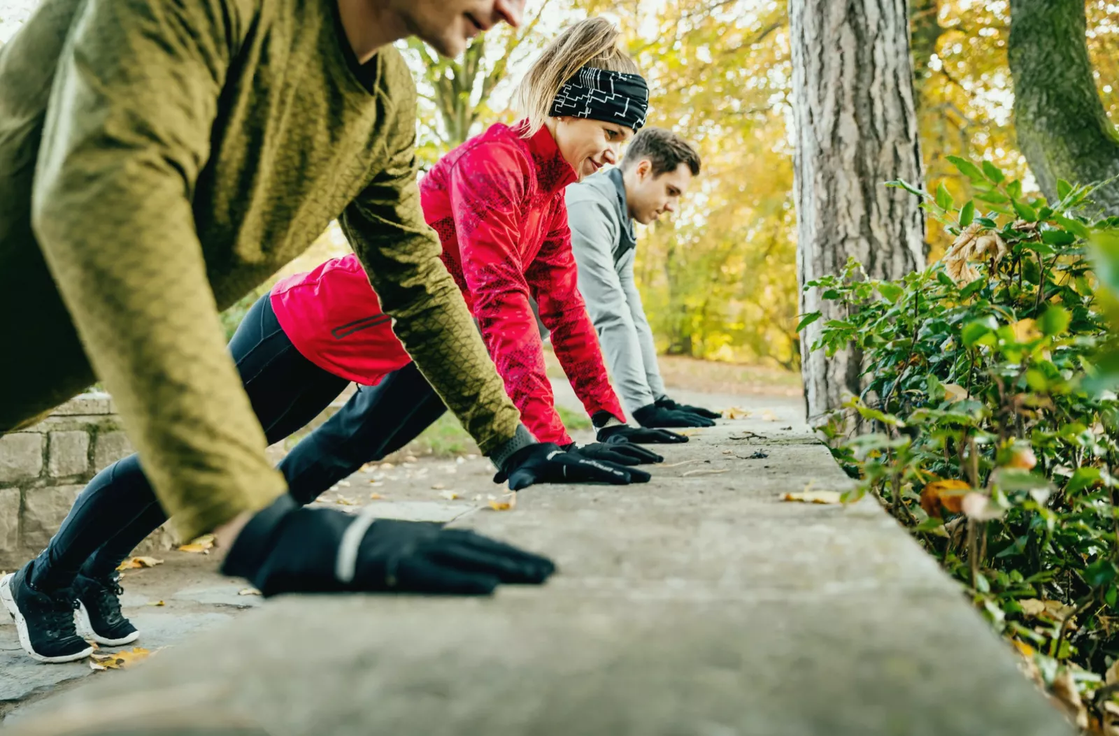Trainer demonstrating correct elbow position at a 45-degree angle during a push-up