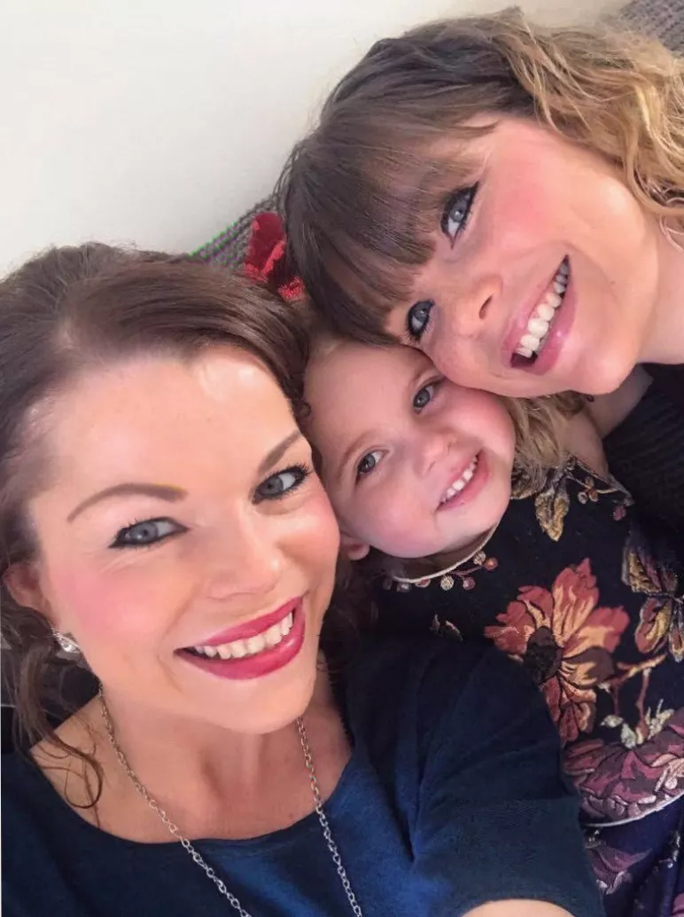 A family photograph showing twin sisters together at a coffee shop