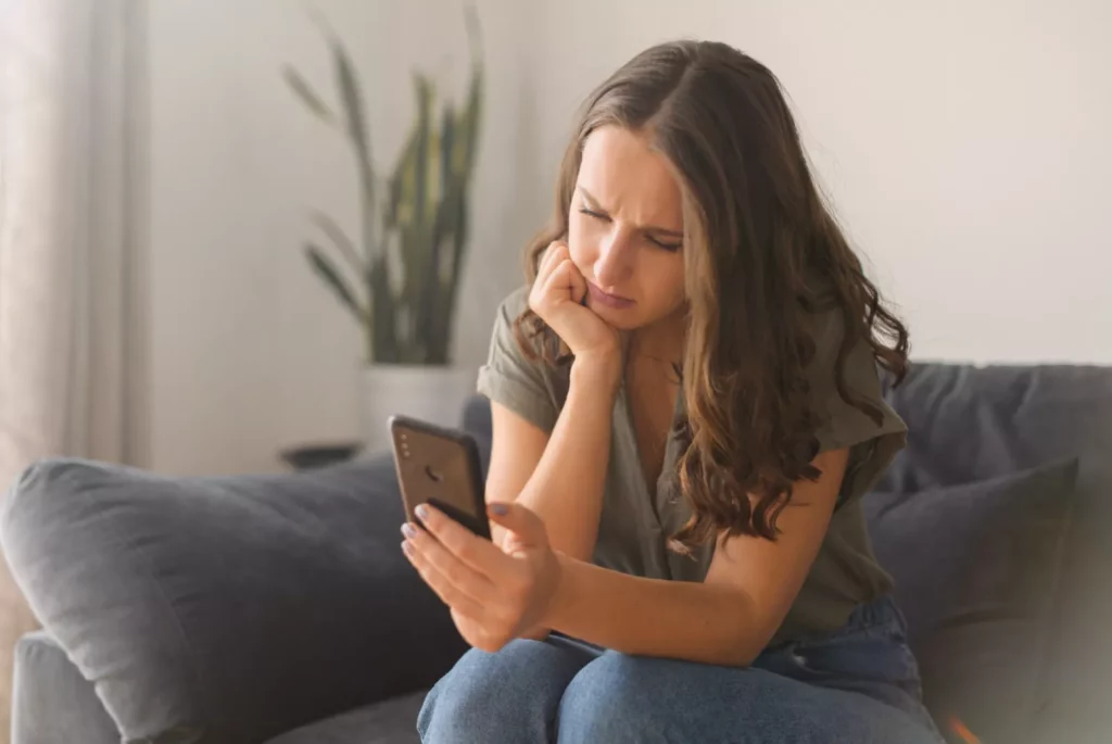 Disturbing statistic could bring social media scrolling to a halt Person scrolling through social media on a smartphone in a living room