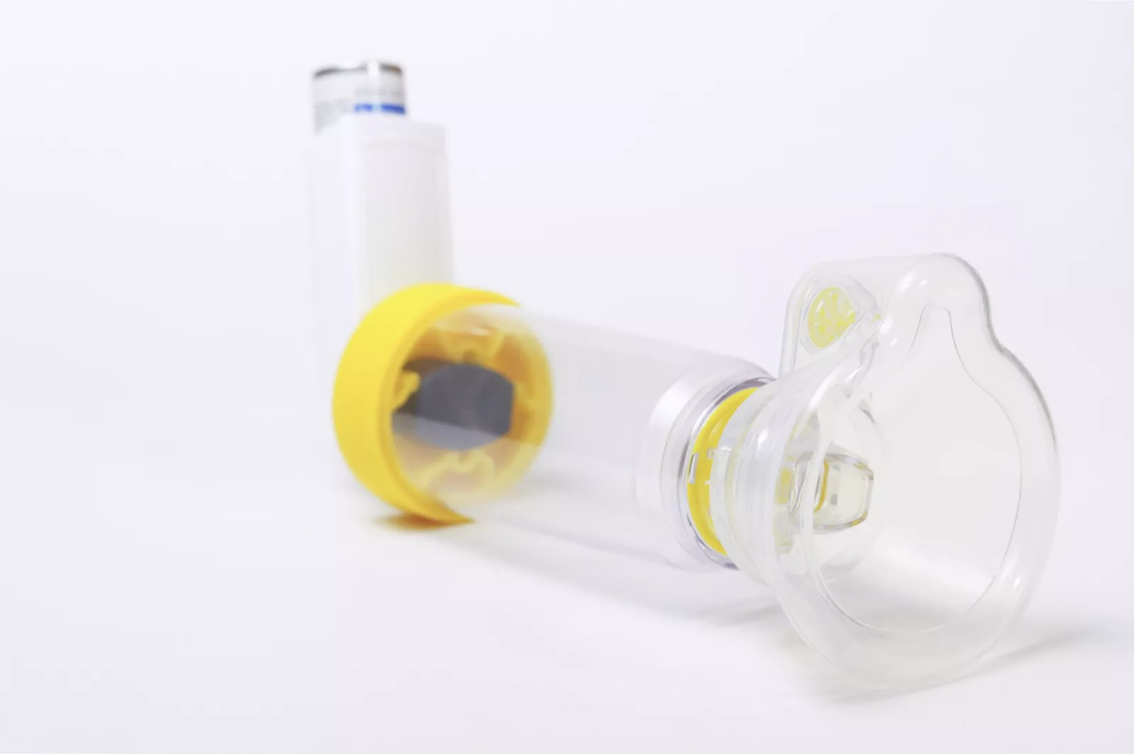 A respiratory patient demonstrating slow, steady inhalation from a spacer mouthpiece