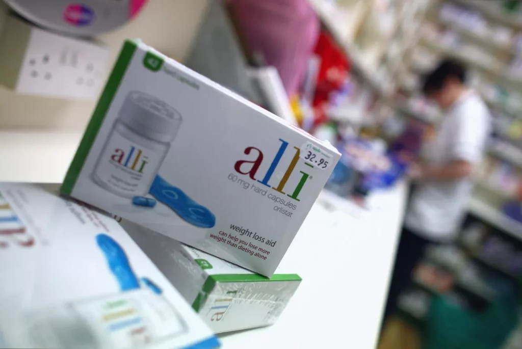 Over-the-counter weight loss pill packaging on a pharmacy shelf