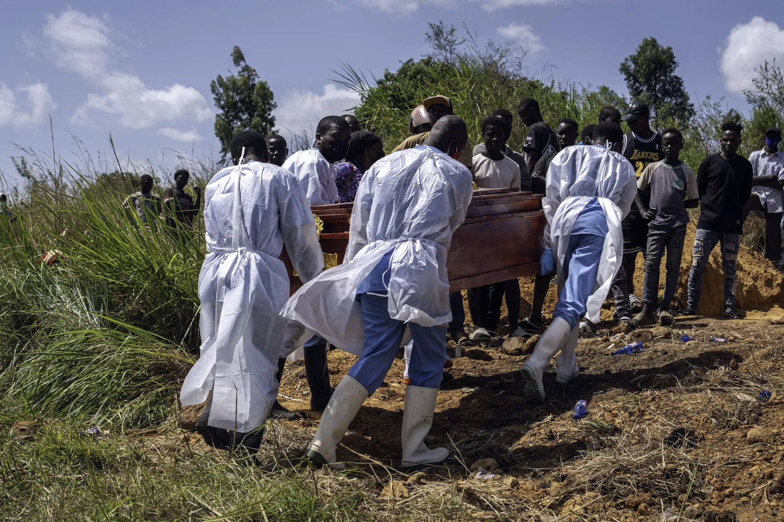 Health workers in protective gear treating patients at an Ebola treatment centre