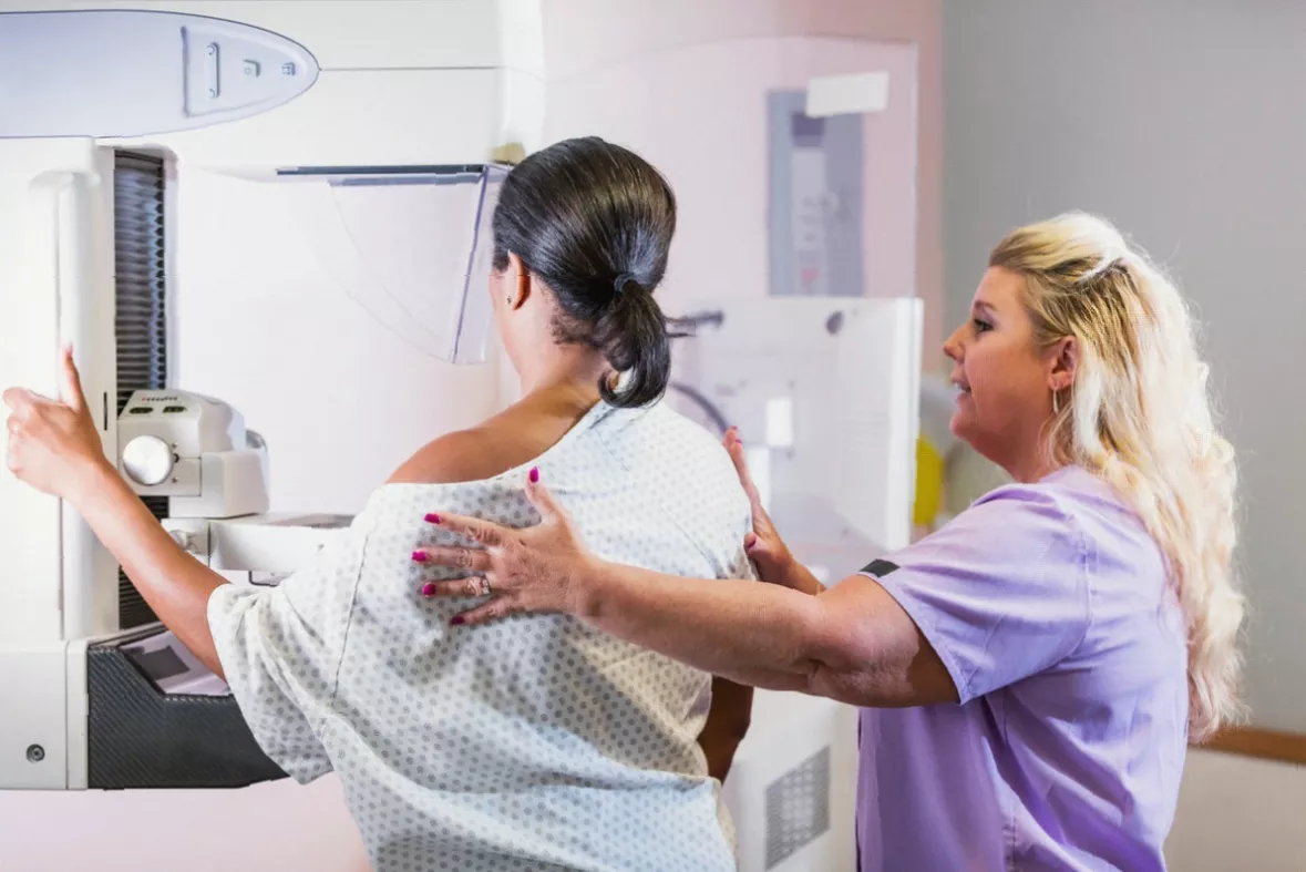 A doctor talking with a younger female patient in a GP consultation room