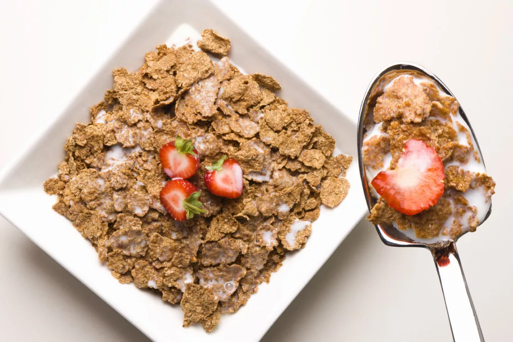 Bowl of bran flakes on a kitchen table under a magnifying glass