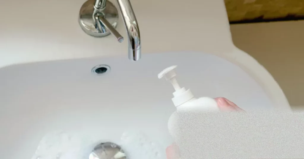 Kitchen counter with a broken soap dispenser next to a metal nutcracker tool