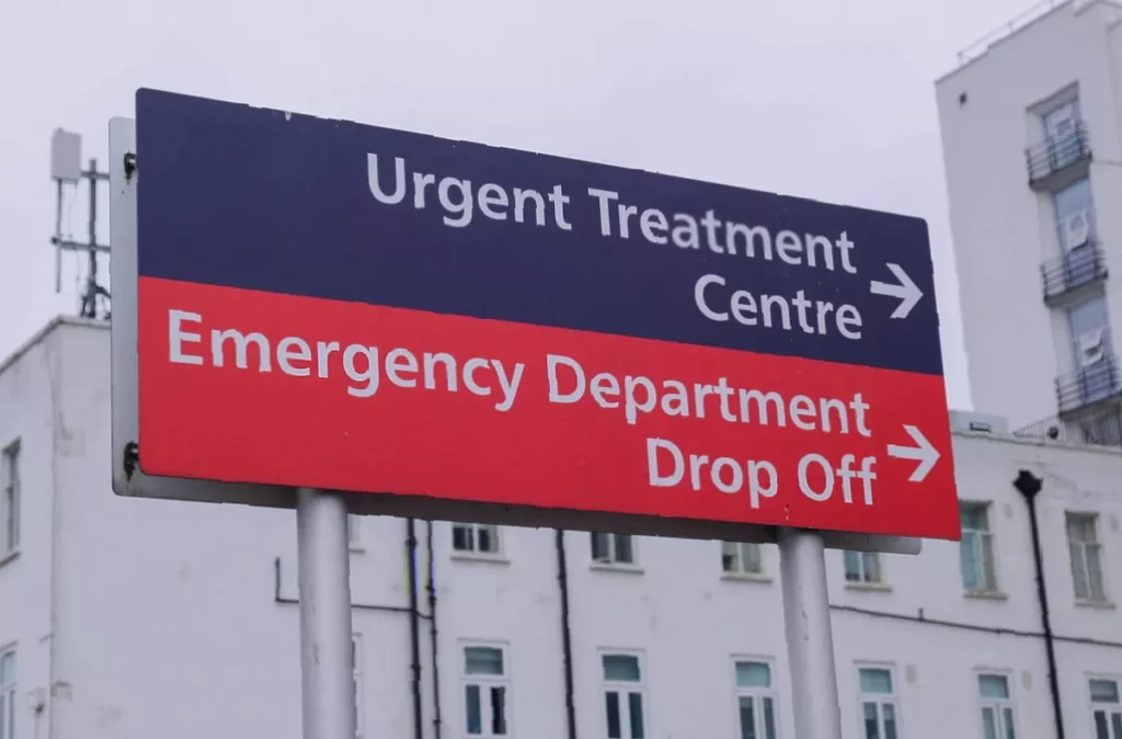 Crowded emergency department corridor at St Helier Hospital with patients on trolleys