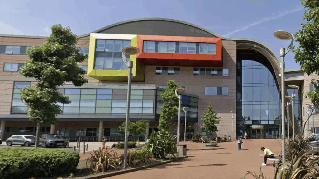 NHS support withheld from autistic boy, 6, over private school attendance A six-year-old boy sitting alone in a classroom, staring out a window