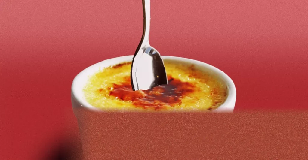 Poorna Bell: food-sharing unappealing without strict rules A woman at a restaurant table with two spoons beside a crème brûlée dish