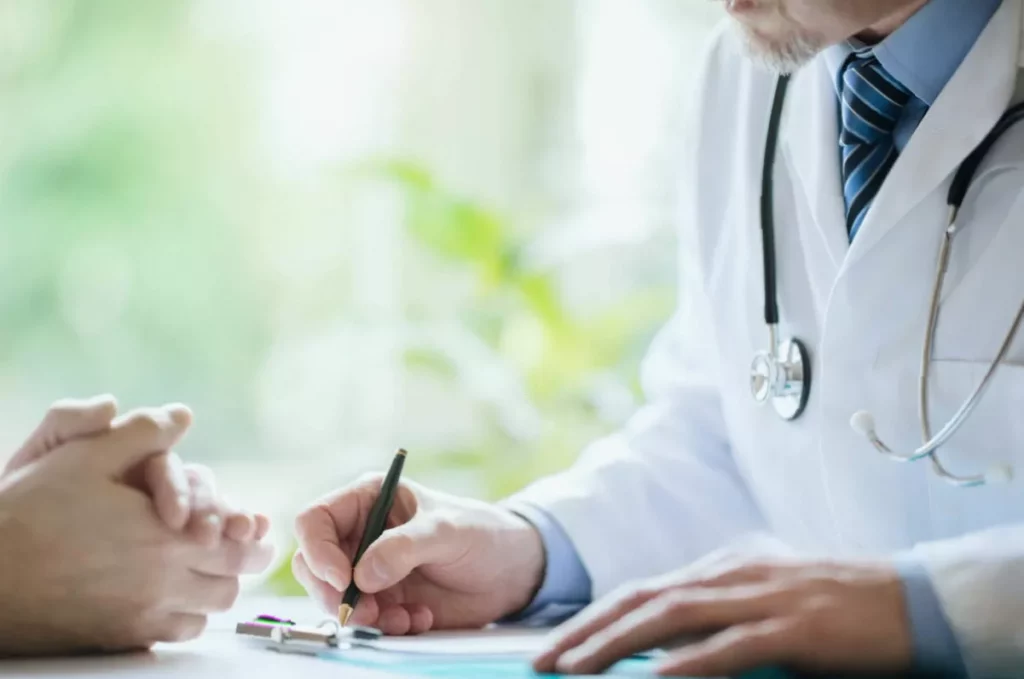 Prescription error leaves girl, 5, bleeding and crying out in agony A young girl sitting on a hospital bed with a parent looking concerned nearby.