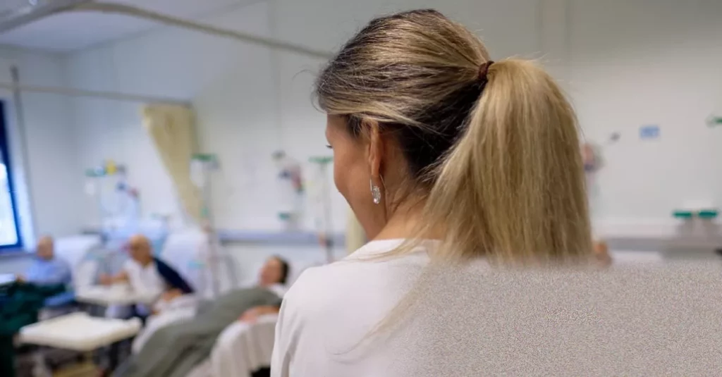 Reduction in NHS waiting lists not a Labour victory, letter argues Hospital staff reviewing patient records at a desk in an NHS office
