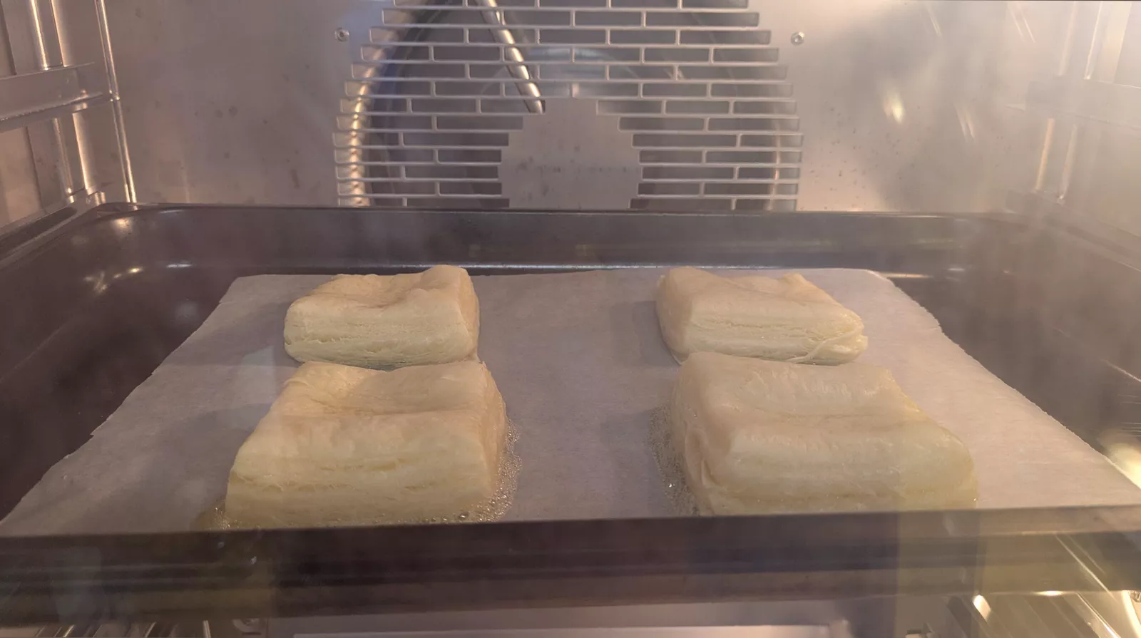 Cross-section of a flaky sausage roll pastry showing layered dough structure