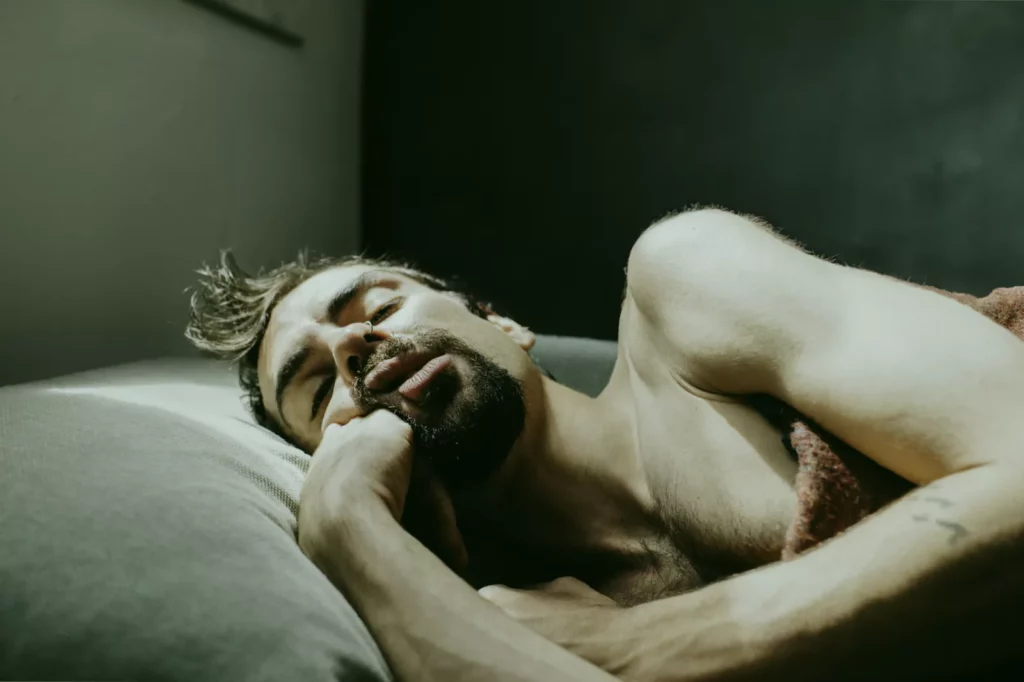 Middle-aged man sleeping peacefully in a darkened bedroom