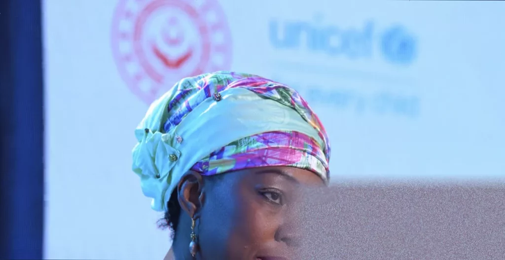 First lady Fatima Maada Bio speaking at a podium in Freetown