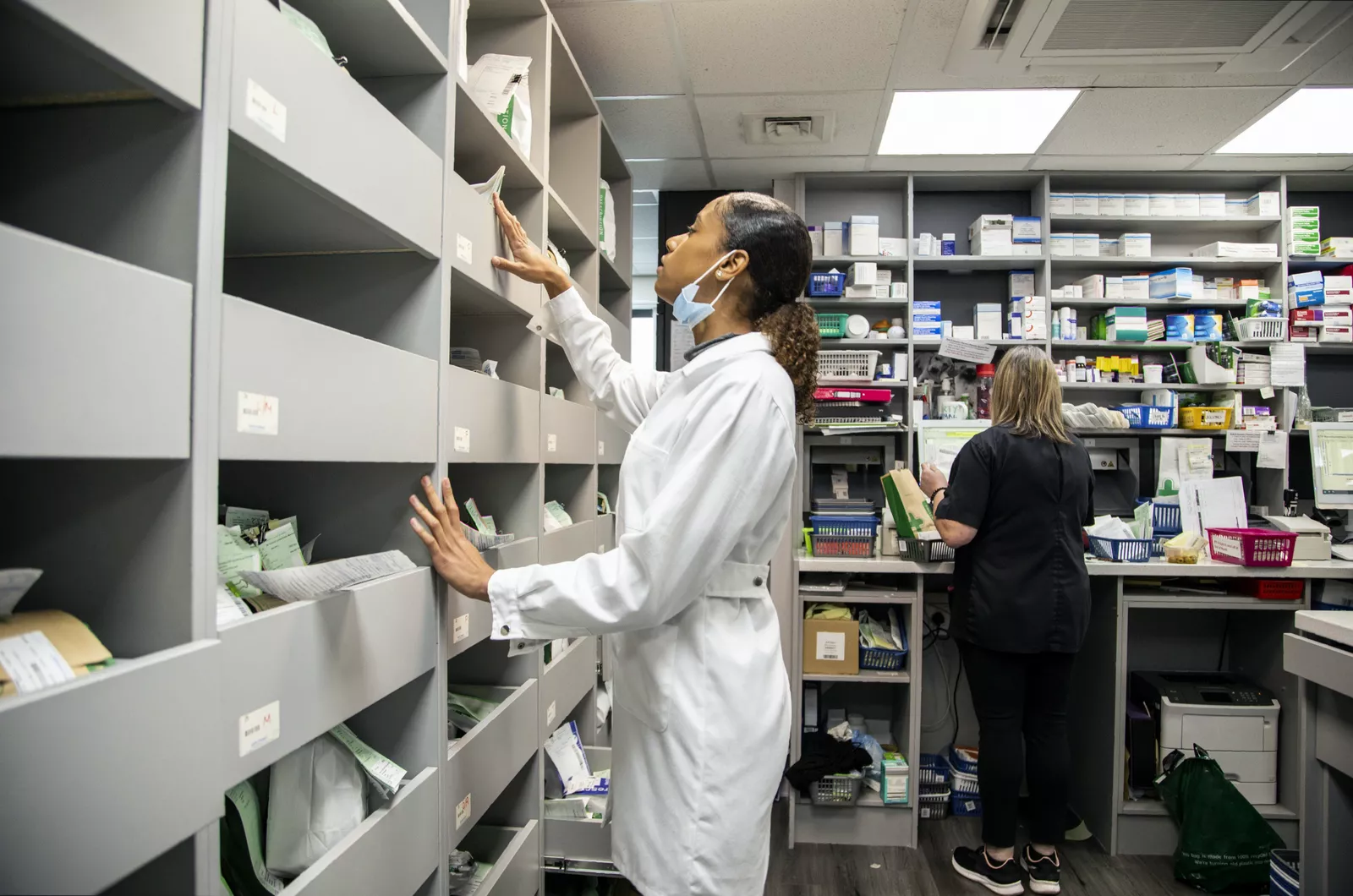 Shelves of prescription medications lined up inside a community pharmacy