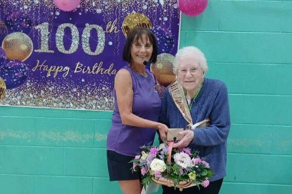 A 100-year-old woman attending a stretch and flex class at a sports centre